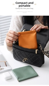 Mini PU leather squeeze pouch in orange and grey showing portable storage in a handbag