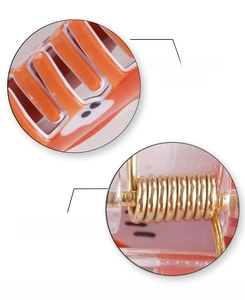 Detail view of smooth fox hair claw clip featuring custom metal spring for strong grip