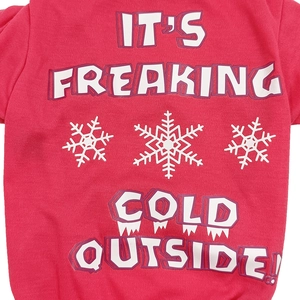 Close-up of pink dog sweater with IT'S FREAKING COLD OUTSIDE text and snowflakes