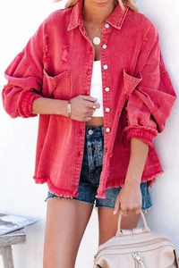 Detail of red distressed denim jacket featuring raw edges and vintage frayed textures