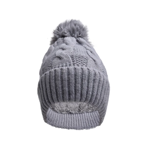 Detailed view of the thick fleece lining and cable knit texture of a warm winter beanie