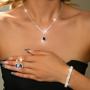 Macro shot of silver-tone jewelry set with sparkling blue pear-shaped zircon stones