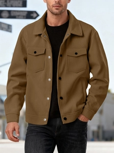 Detailed close-up of brown corduroy shirt jacket featuring button pockets and ribbed texture