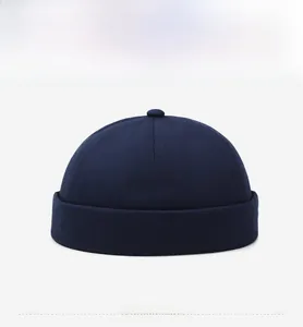 Front view of a dark blue docker hat featuring a minimalist brimless rolled cuff design