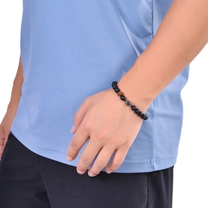 Men's matte black beaded bracelet with tiger eye stone on wrist for son and father gift