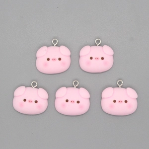 Detailed view of five cute pink cartoon pig head charms with metal rings for jewelry making