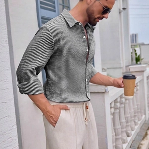 Men's olive green striped long sleeve cotton shirt paired with beige casual pants