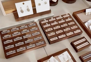 Detailed overhead view of premium walnut wood jewelry display tray with multiple ring slots