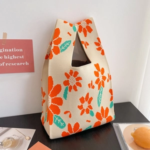 Macro shot of knitted tote bag showing orange floral texture and premium woven cotton