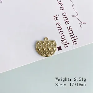 Close-up of golden crescent moon metal pendant with engraved stars for DIY jewelry