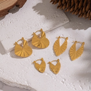 Gold geometric earrings set with heart and leaf shapes featuring radial textures