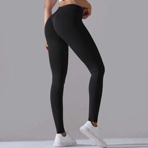 Detail view of seamless black yoga pants with cross waist and peach butt lifting effect