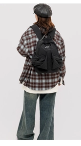 Detailed view of a black space series backpack with drawstring closure and flap design