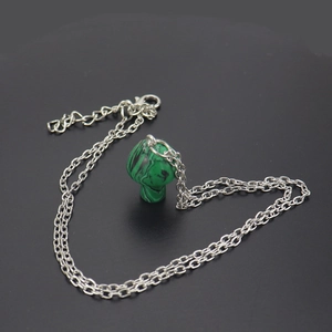 Macro view of a 2cm green stone mushroom pendant with a silver chain and lobster clasp