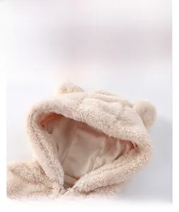 Close-up of baby plush hooded coat detail with cute 3D bear ears and soft fleece texture