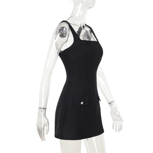 Close-up of black sleeveless tweed mini dress featuring side pockets and silver buttons