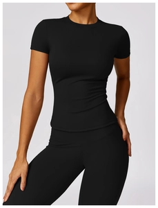 Close-up of matte black quick-dry yoga top and high-waisted leggings on a model