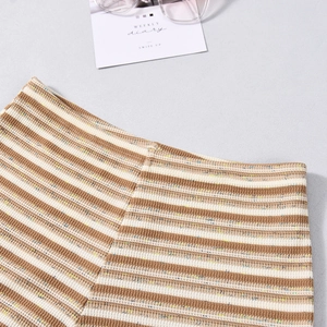 Detail of striped knit crop top and skirt set showing multicolor mixed yarn texture