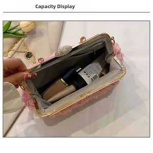 Top view of pink floral clutch capacity showing interior space and gold chain strap