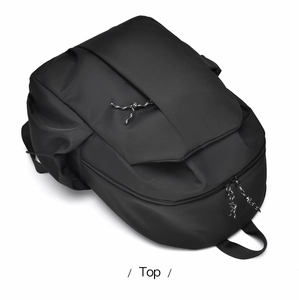 Top view of black nylon backpack featuring reinforced handle and woven zipper pulls