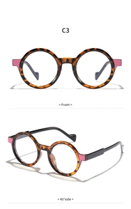 Detail view of round tortoiseshell glasses frame with pink decorative temple accents