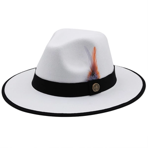 White wide-brim felt fedora hat with black ribbon, feathers and golden vintage badge