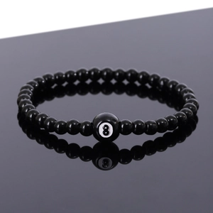 Polished black bead bracelet featuring a lucky number 8 billiards ball on a reflective surface