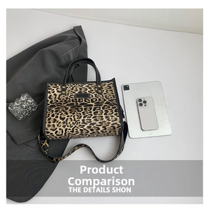 Flat lay of a leopard print tote bag with black handles and a wide shoulder strap