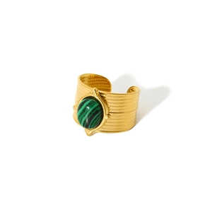 Detailed macro view of retro 18k gold plated ring featuring an oval green stone inlay