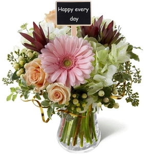 Mini wooden chalkboard sign with Happy every day text inserted in a lush flower bouquet