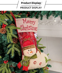 Detail of a red Christmas stocking with snowman doll hanging on a Christmas tree