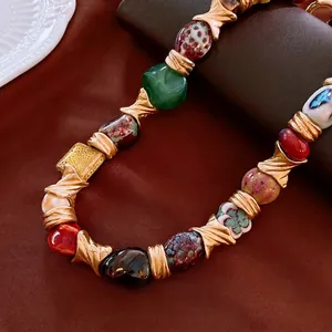 Vintage bohemian necklace with colorful ceramic beads and gold textured metal accents