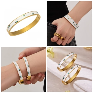 Detailed views of gold evil eye bangle with white enamel and turquoise stones