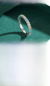Detail of S925 silver and gold eternity rings with colorful round zircon stones
