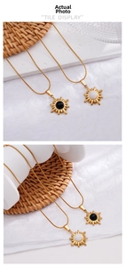 Detail of sun pendant necklaces with black onyx and white shell inlay on gold snake chains