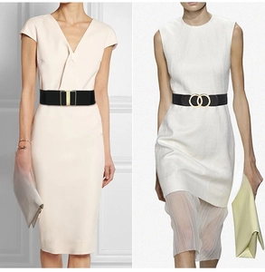 Detail of black elastic waist belts with gold rectangular and double ring metal buckles
