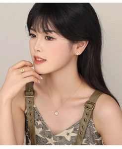Golden S925 silver necklace set with coin pendant, stud earrings and wavy ring on model