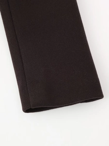 Close-up detail of dark brown wool coat sleeve showing high-quality fabric texture