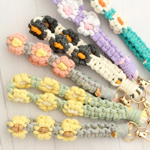Handmade woven daisy flower wrist straps with gold lobster clasps in six vibrant colors