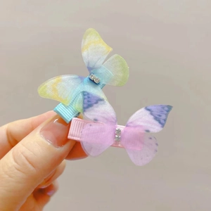 Detailed shot of two gradient tulle butterfly hair clips featuring sparkling rhinestones