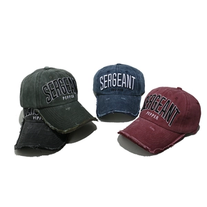 Macro shot of Sergeant Pepper embroidery and distressed brims on cotton baseball caps