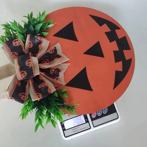Detailed view of the 206g Halloween pumpkin wood sign with burlap bow and artificial plants