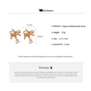 Detailed specs of bow earrings with pearls and zircon teardrops in gold plating