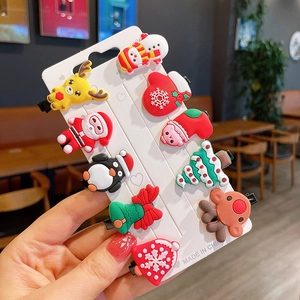 Close-up of 10-piece Christmas hair clip set featuring Santa, reindeer and tree shapes