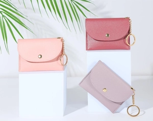 Detailed view of pastel PU leather mini wallets featuring gold metal charms and keychains