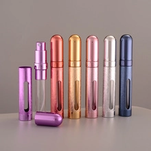 Disassembled 10ml refillable perfume atomizer showing aluminum shell and glass inner vial