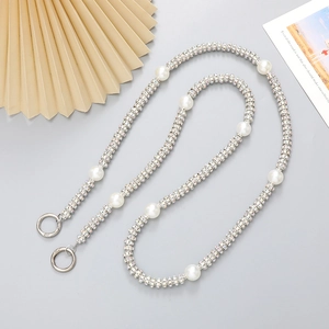Detail of silver chain strap featuring sparkling rhinestones and elegant faux pearls