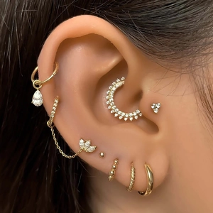 Detail of gold star and crescent moon earring set with sparkling zircon stones