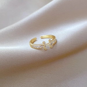 Detailed view of gold-plated H-shaped ring featuring pavé set sparkling white zircons