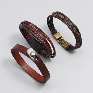 Detailed set of three vintage men's leather bracelets with metal studs and magnetic clasps